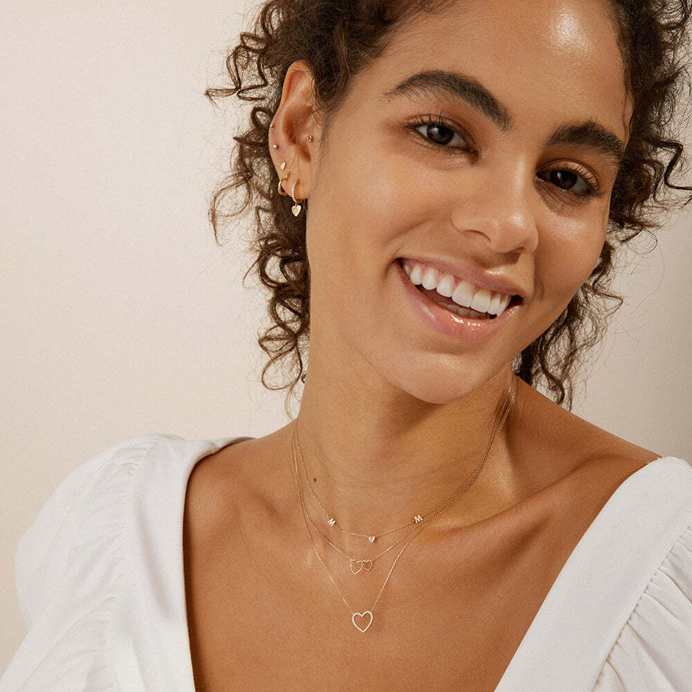 Our Emma Open Diamond Heart Necklace will make a beautiful addition to your jewelry collection. The open heart features an elegant outline of shimmery diamonds suspended from a shining gold chain. EMMA | Open Diamond Heart Necklace