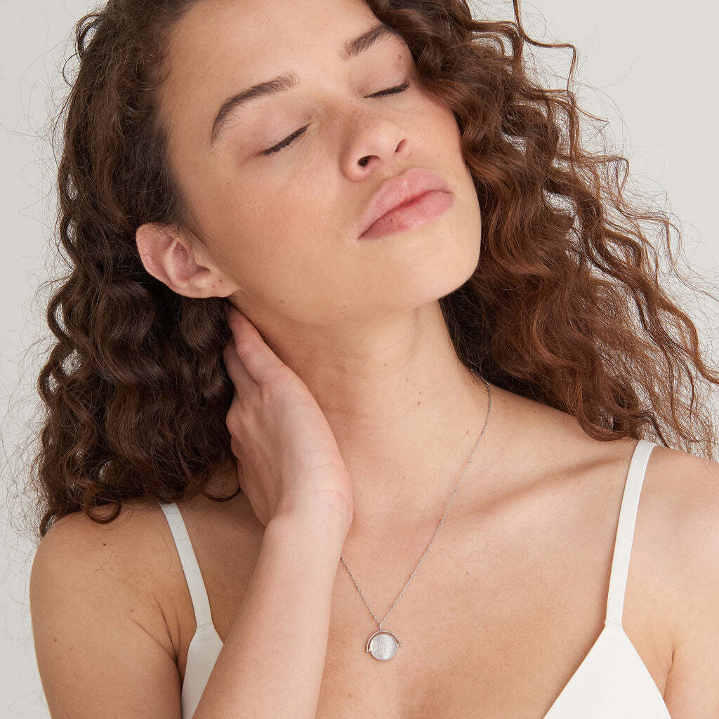 An on-trend pendant necklace with a seasonal twist, embrace the spirited adventure trend with this statement necklace. Set on a delicate chain, the pedant design grabs all the attention. Crafted in high-quality mother of pearl, you’ll find an embossed sunbeam emblem, perfectly paired with the iridescent finish of the pearl. Want to layer? Just add simple chains for a chic and simple bohemian vibe. SUNBEAM EMBLEM SILVER NECKLACE