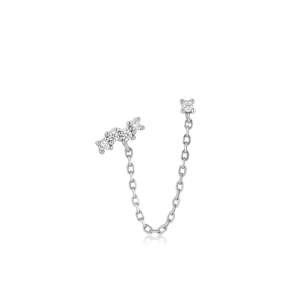 Pretty meets edgy, this sparkling drop chain barbell earring takes your ear stacking credentials to the next level in an instant. A single cubic zirconia stone is joined to a celestial-inspired cluster of sparkle with a simple and delicate gold chain detail to serve up a simple look with a twist. Style yours with your most sparkling studs. Silver Celestial Drop Chain Barbell Single Earring