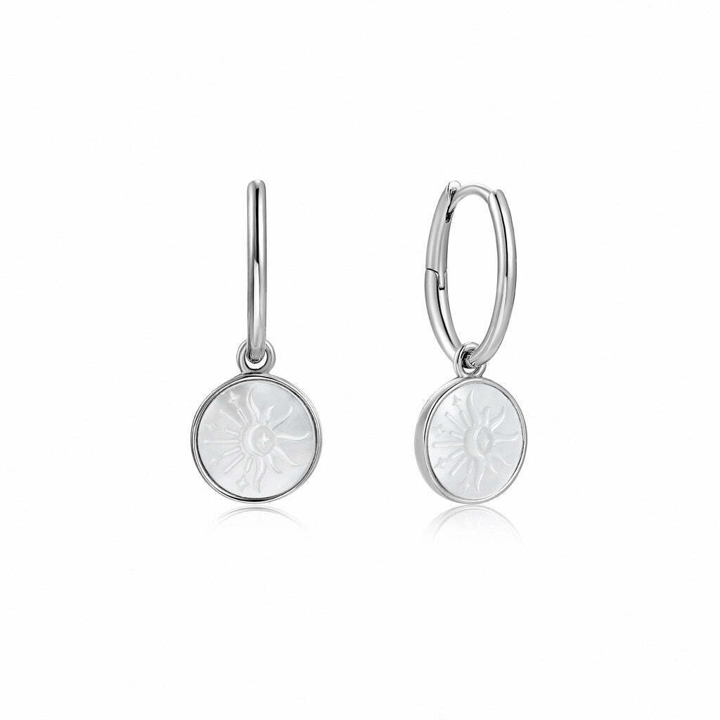 The perfect way to update your everyday earring collection with this season’s pearl trend, these stunning and simple huggie hoops make a stylish choice. Fitted onto a smooth and simple oval huggie hoop, discover a disc-shaped circular droplet, featuring the collection’s signature embossed mother of pearl. Finished with a sunbeam emblem imprint, add these hoops to your go-to everyday earring stack. Sunbeam Emblem Silver Huggie Hoop Earrings