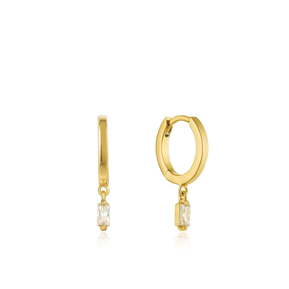 Add a touch of shimmer to your everyday wardrobe with these gold huggie hoops featuring a single cubic zirconia baguette, guaranteed to make you shine. Gold Glow Huggie Hoops