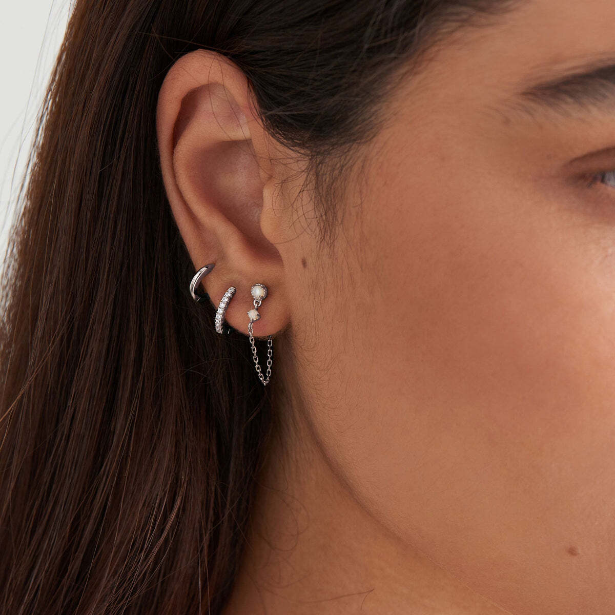 When you’re in the mood for some added sparkle for every day, you can’t go wrong with these stunning huggie hoop earrings in silver. Crafted with the shimmer of cubic zirconia stones, elevate your earring stack with the perfect sparkle huggie hoops. Stack with additional? huggies for a dimensional on-trend look. Silver Sparkle Huggie Hoop Earrings