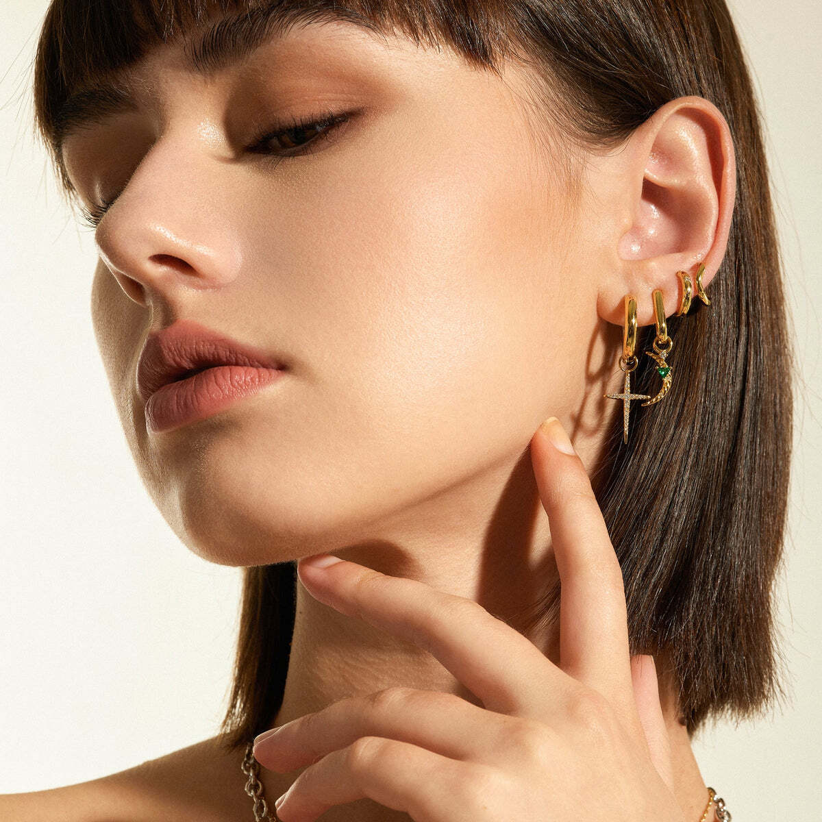 Lean into this season's cross trend with this sparkling cubic zirconia cross earring charm, perfect to add sparkle and detail to any earring stack. Crafted from 925 sterling silver with 14kt gold plating and finished with rows of shimmering cubic zirconia stones, this charm adds shine to your jewelry look, day or night.Details:Material: stealing sliver with 14k gold plated Dimensions: 19mm x 12mmStone Type: cubic zirconiaStone Size: 0.8mm, 0.9mm, 1.0mm, 1.1mm, 1.2mm, 1.4mm GOLD CROSS EARRING CHARM