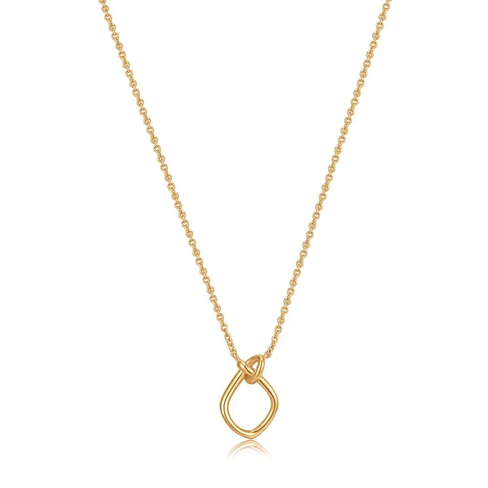 Product Description:A simple pendant done the contemporary way, opt for this stunningly minimal knotted pendant necklace set on a delicate chain. Featuring the unique detailing of this season’s knot aesthetic, this enviable piece is your new everyday jewelry go-to. The perfect piece to complete a subtle layered look.Our Gold Knot Pendant Necklace is also available in silver.Product Details:• Material: 14kt gold plated on sterling silver• Necklace length: 400mm with 50mm extender• Pendant size: 9mm x 13mm• Weight: 2.4g GOLD KNOT PENDANT NECKLACE