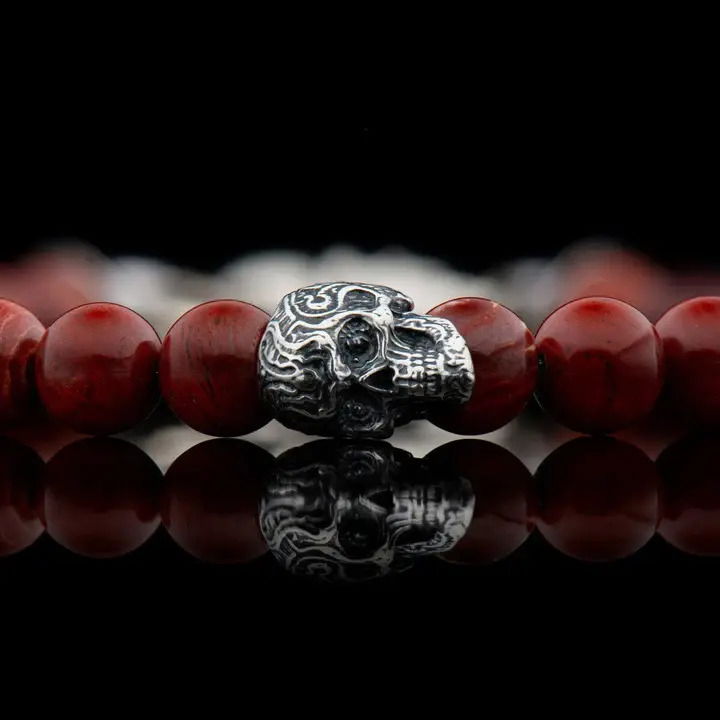 We love skulls, especially the ‘sugar skull’ style, and we proudly offer this new version of our classic, a little smaller and refined, truly unisex, great on its own or stacked with other pieces on the wrist. The ‘Red Baron’ bracelet features five skulls in sterling silver, flanked by the understated opulence of red snakeskin jasper beads and finished with our sterling swivel lobster clasp. Built on welded aircraft cable for durability. RED BARON