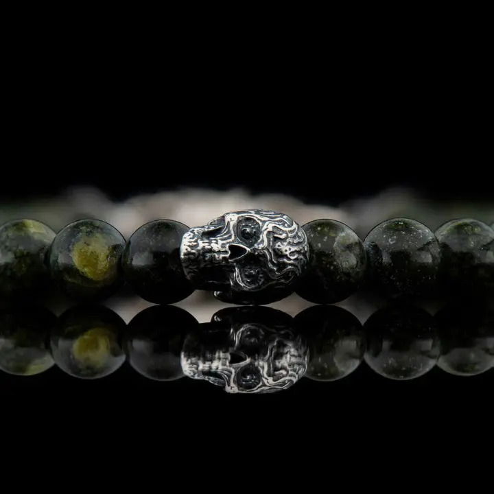 We love skulls, especially the ‘sugar skull’ style, and we proudly offer this new version of our classic, a little smaller and refined, truly unisex, great on its own or stacked with other pieces on the wrist. The ‘Spanish Moss’ bracelet features five skulls in sterling silver, flanked by the understated opulence of green serpentine beads and finished with our sterling swivel lobster clasp. Built on welded aircraft cable for durability. SPANISH MOSS