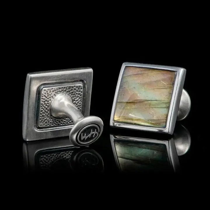 Bring the colors of the sky at dusk to life with these beautiful cufflinks. Sculpted in sterling silver and showcasing labradorite; undulating tones of blue, green, purple, and black play against the natural grain of the material, revealing nature’s majesty. Wears with a wide range of colors and textures – an essential accessory for every man. LABRADORITE DUO