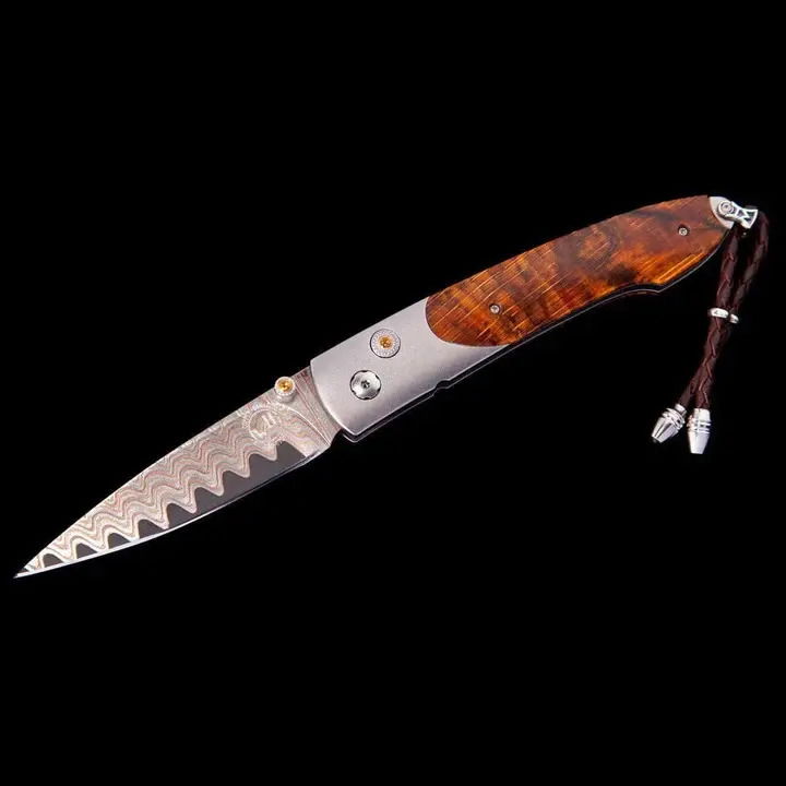 The Lancet 'Summerset' features a light and resilient frame in aerospace grade titanium that is finished with a fine blast-polishing. It also features lustrous inlays crafted from an orange spalted beechwood that captures a moment in time when decay start Lancet 'Summerset' Pocket Knife | William Henry