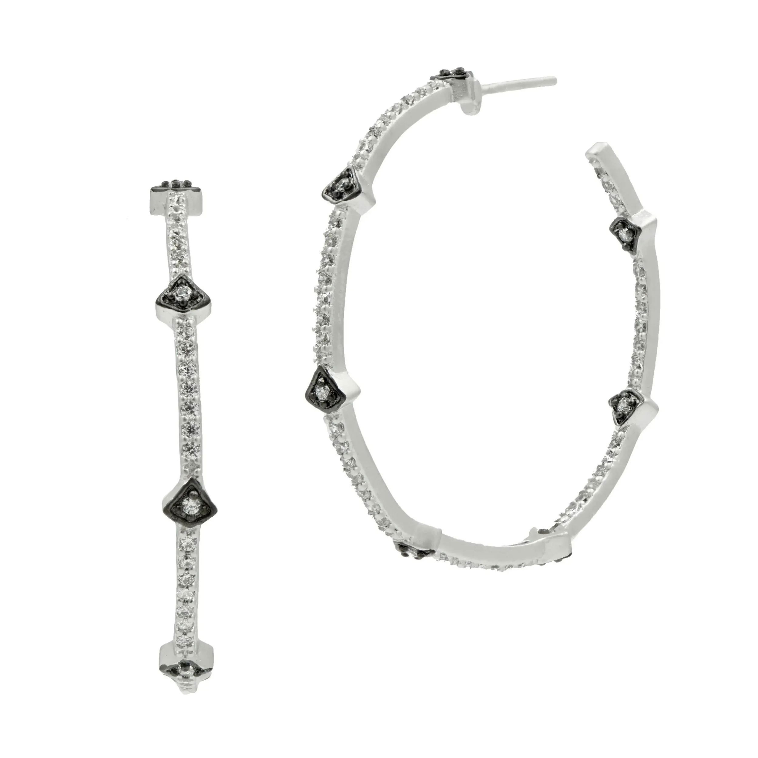Say hello to your new favorite hoops! Our Best-Selling Pavé Arrow Hoop Earrings are a must-have for anyone who loves a great pair of hoops! Inspired by the streets of Brooklyn, with pavé detailing inside and out, plus chic mixed metal embellishments, these light-weight hoops are designed to shine from any angle. It’s no wonder they’re our #1 best-seller!Crafted with a .925 Sterling Silver core for unmatched durability, ensuring your piece stands the test of time.Each clear cubic zirconia stone is meticulously hand-set for exceptional brilliance and shine, showcasing the ultimate in craftsmanship. Available in multiple finishes of our iconic 14K Gold two-tone look. Thoughtfully engraved with the iconic FREIDA ROTHMAN insignia, a symbol of empowerment and refined Brooklyn design. 1.5 inch length and widthPerfect medium size for comfortable and effortless wear. Fishhook earring for easy put on and take off. FREIDA ROTHMAN HOOP EARRINGS