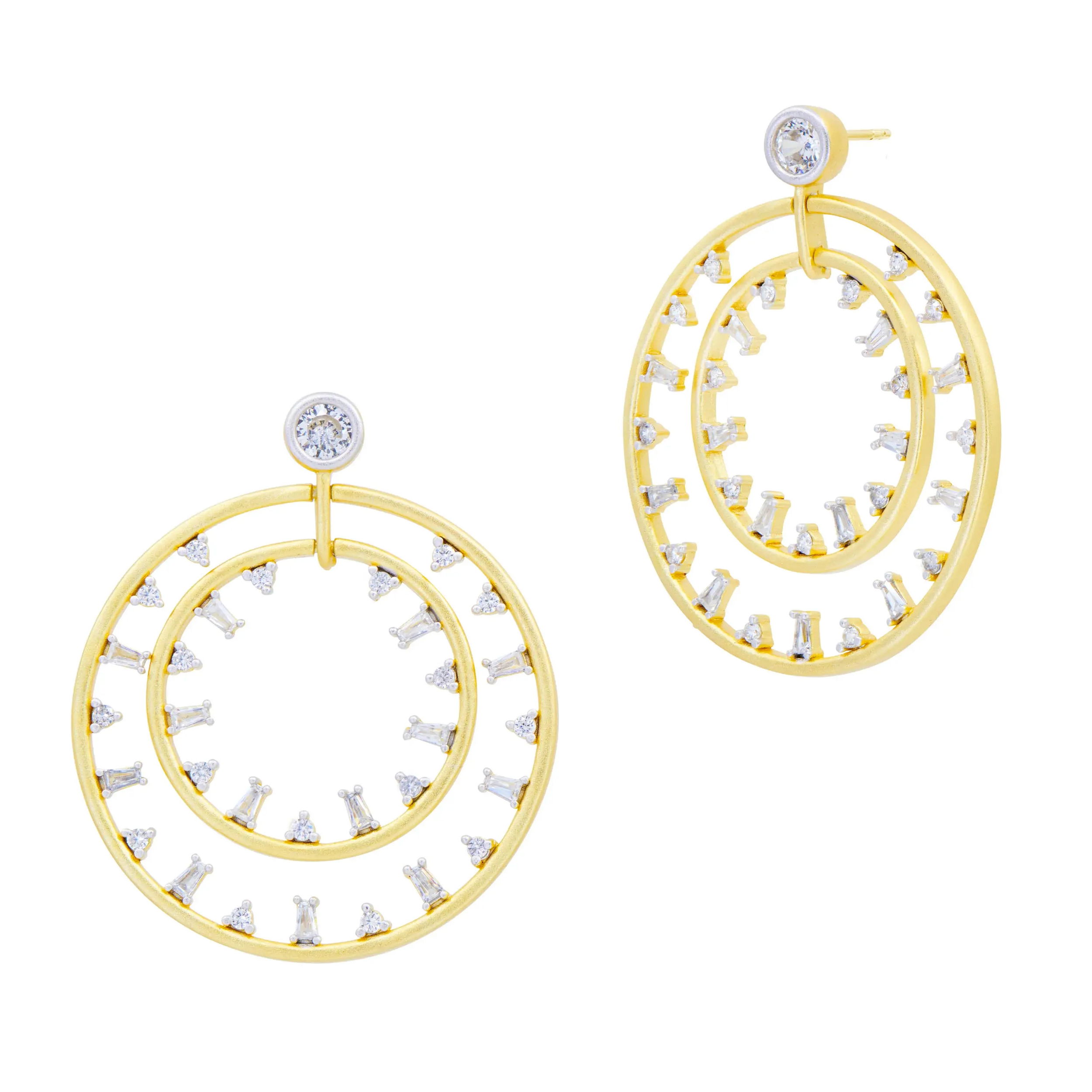 Add endless sparkle and a bold pop to your ear! Drawing inspiration from the sparkling lights of Brooklyn, the Midnight Mosaic Double Open Hoop Earring is the perfect accessory to make an unforgettable impression. Featuring a captivating fusion of Freida’s re-imagined gold and silver, the matte finish is adorned with show-stopping baguette and round-cut handset stones, exuding pure glamour with every movement.14K matte gold and platinum rhodium finishSterling silver coreHandset clear cubic zirconia stonesEngraved with FREIDA ROTHMAN insignia MIDNIGHT MOSAIC DOUBLE OPEN HOOP EARRINGS