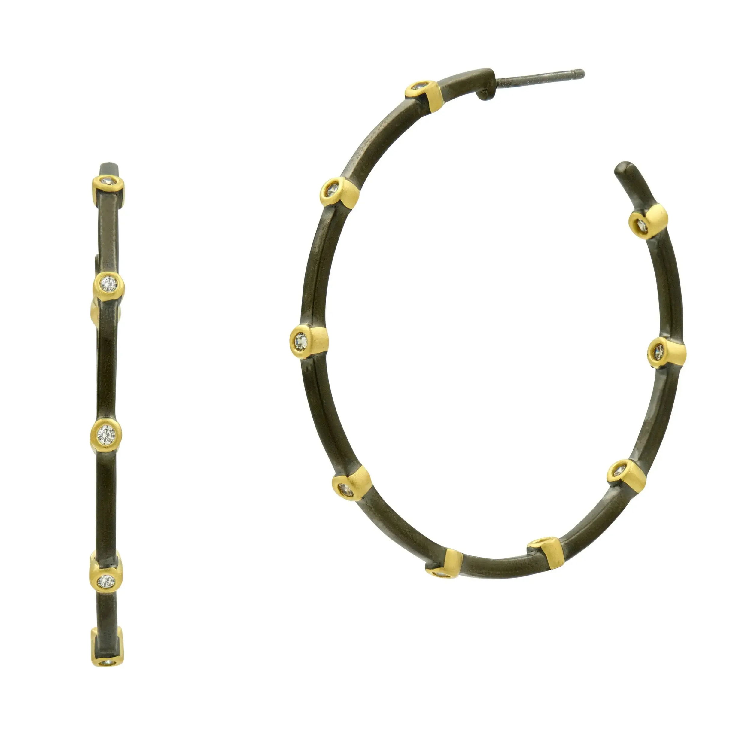If you’re searching for the ultimate versatile hoop, look no further! Inspired by the grit and glam of Brooklyn, our Signature Thin Bezel Station Hoops are the perfect blend of chic and charm. With a lightweight feel and a touch of bezel detail inside and out, they’re your go-to for effortlessly transitioning from day to night. Crafted with a .925 Sterling Silver core for unmatched durability, ensuring your piece stands the test of time.Each clear cubic zirconia stone is meticulously hand-set for exceptional brilliance and shine, showcasing the ultimate in craftsmanship. Available in multiple finishes of our iconic 14K Gold two-tone look. Thoughtfully engraved with the iconic FREIDA ROTHMAN insignia, a symbol of empowerment and refined Brooklyn design. 41mm hoop diameterPerfect medium size for comfortable and effortless wear. 14K Gold earring post with a large back to provide an easy lift for your ear. YOUR GO-TO BEZEL HOOP