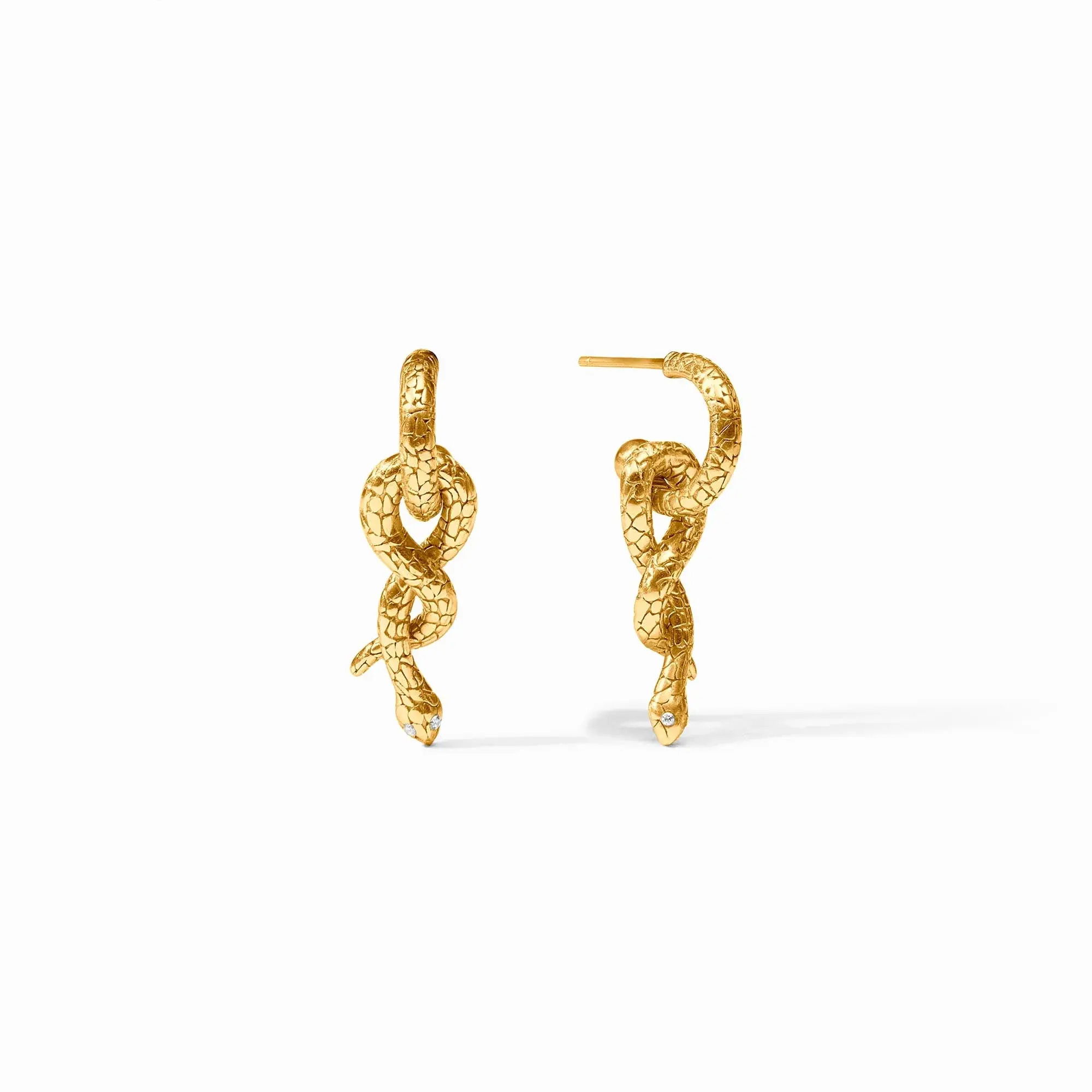 Lithe, lifelike, luxurious golden serpents with abstract geometric scales and glittering gemstone eyes knot around themselves, swaying from huggie hoops with matching snakeskin texture. Snake Hoop & Charm Earring
