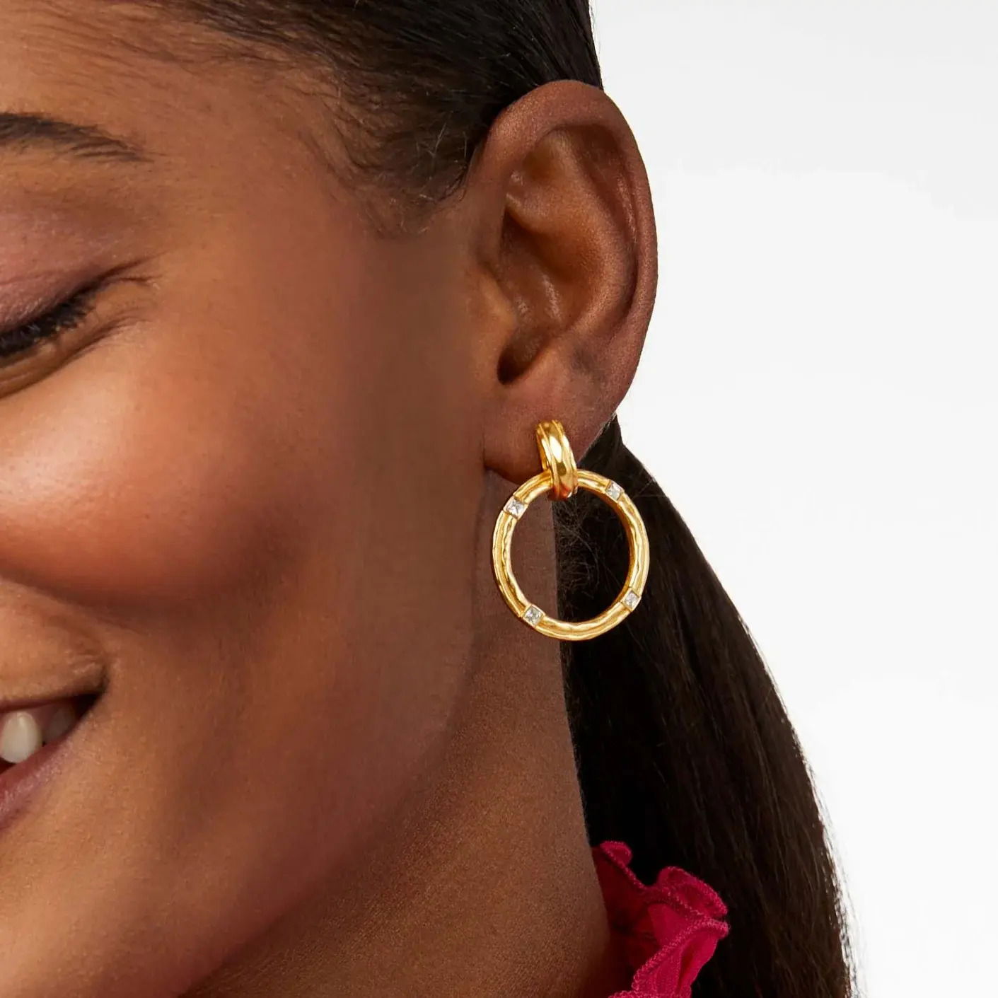 Delicate doorknocker earrings featuring lightly hammered golden orbitals set with CZs that catch the light as they move. Astor Doorknocker Earring