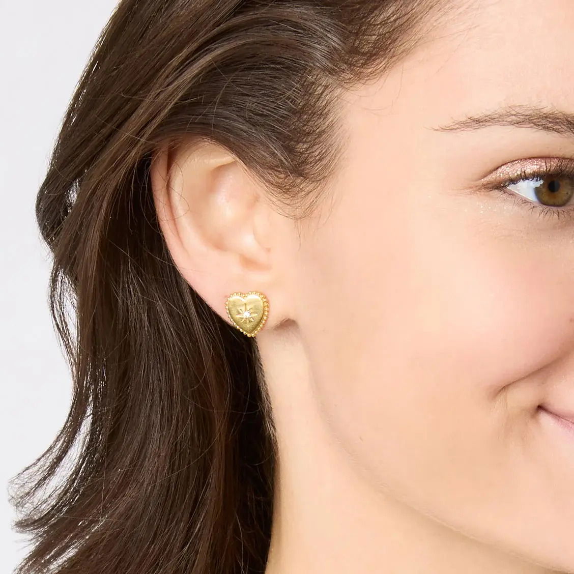 Each of these vintage-inspired golden heart studes features sparkling engraved gemstone stars and delicate beaded edges. Heart Statement Earring