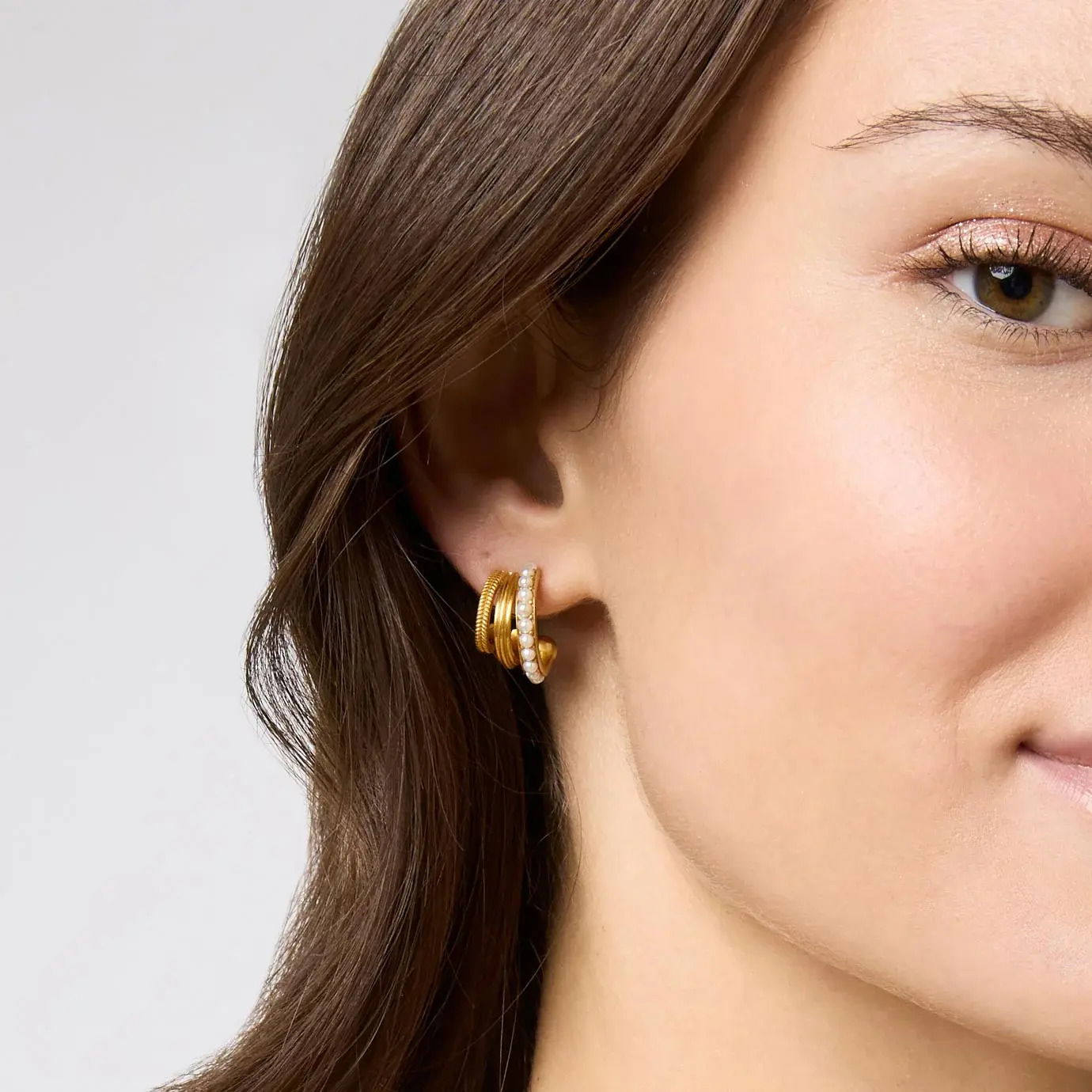 This inventive earring expertly layers three luxe hoops into one, with stone-studded gold on the inside, fluted ridges in the middle, and delicate braiding on the outside. Hydra Triple Hoop