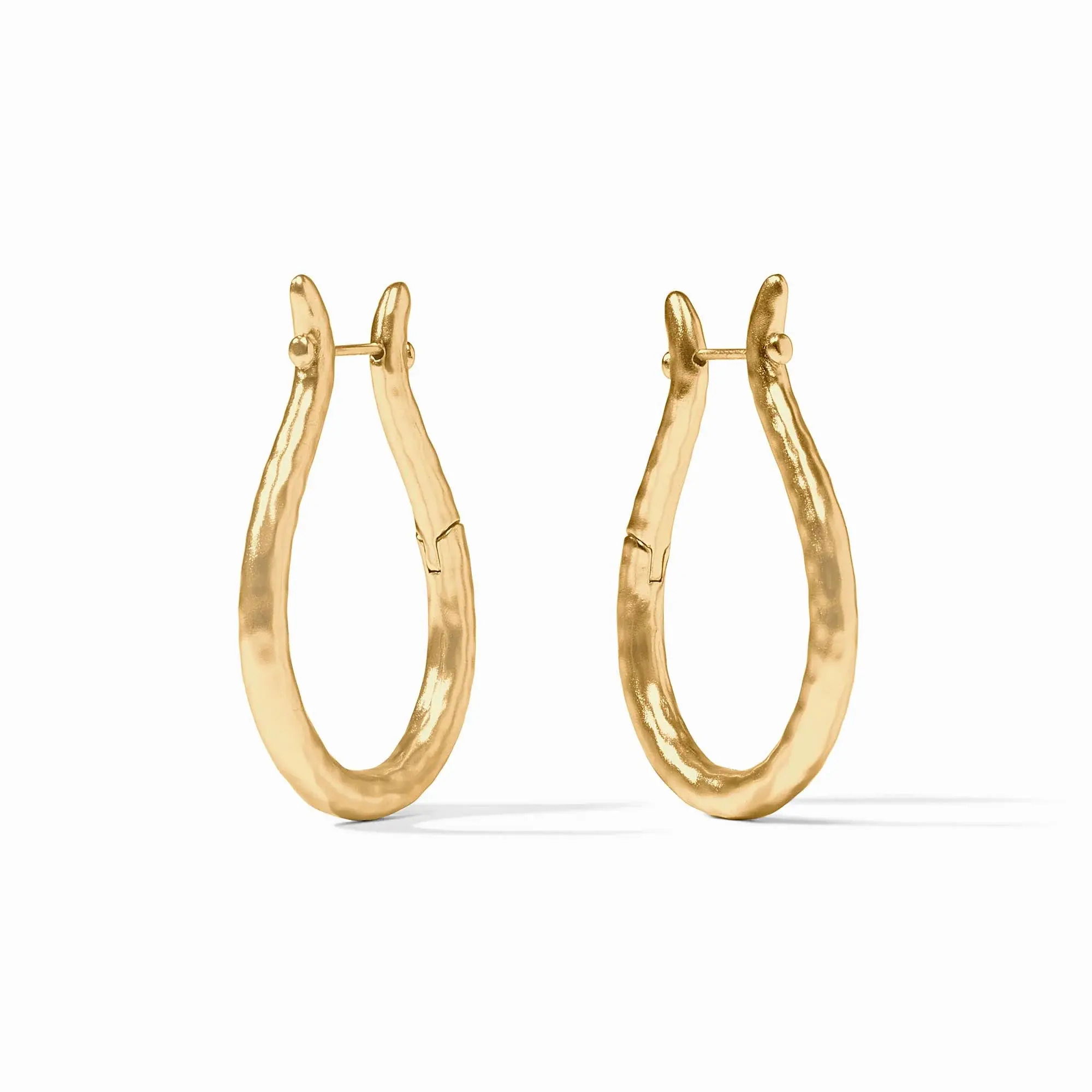 Brimming with timeless equestrian elegance, these lightly hammered golden hoops recall the form of vintage bridle rings. Saratoga Hoop