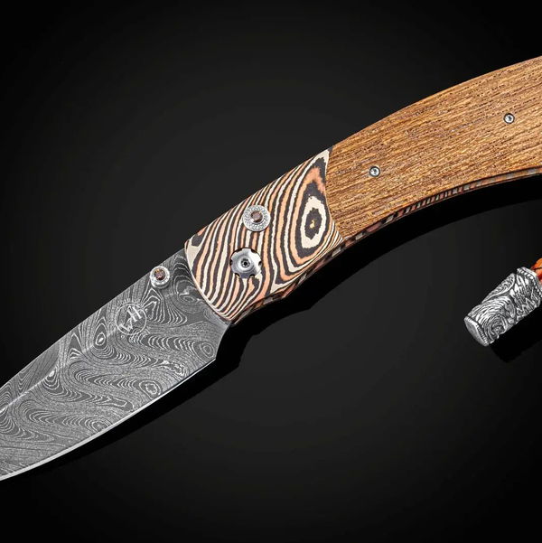 Closeup photo of Spearpoint 'Fighting Spirit' - Hand-forged mokume gane folding knife with USS California wood