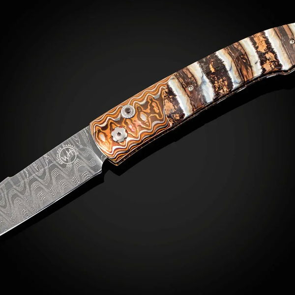 Closeup photo of Mammut - Automatic opening folding knife with 'Wave' mokume and woolly mammoth tooth