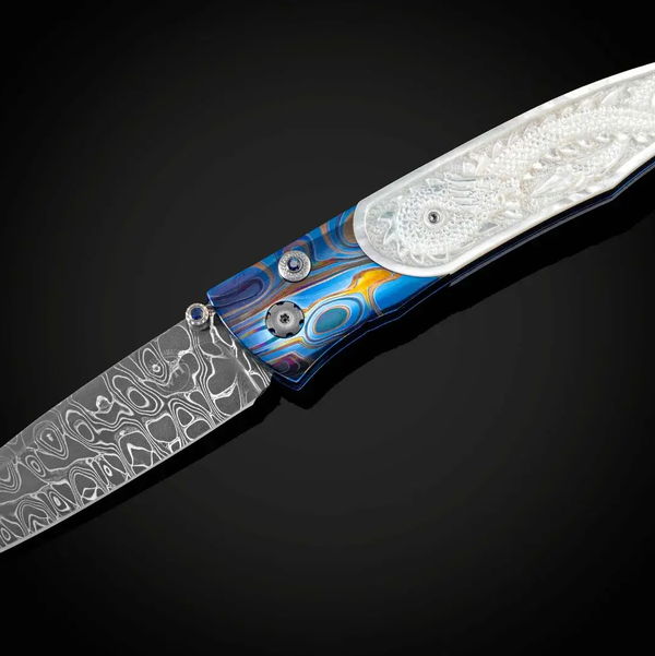 Closeup photo of GenTac 'Dragon Skin' - Titanium folding knife with carved pearl and hand-forged damascus