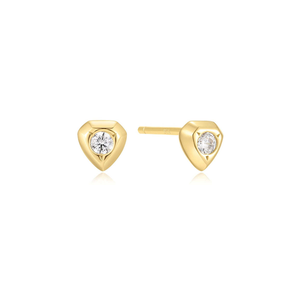 Product Description: Embrace your inner strength and confidence with these shield studs. Designed for the fearless woman who commands attention, each earring features a small shield adorned with a single sparkling cubic zirconia stone. Mix and match with other huggies and hoops to making a statement. Product Details: ? Gold Sparkling Shield Stud Earrings