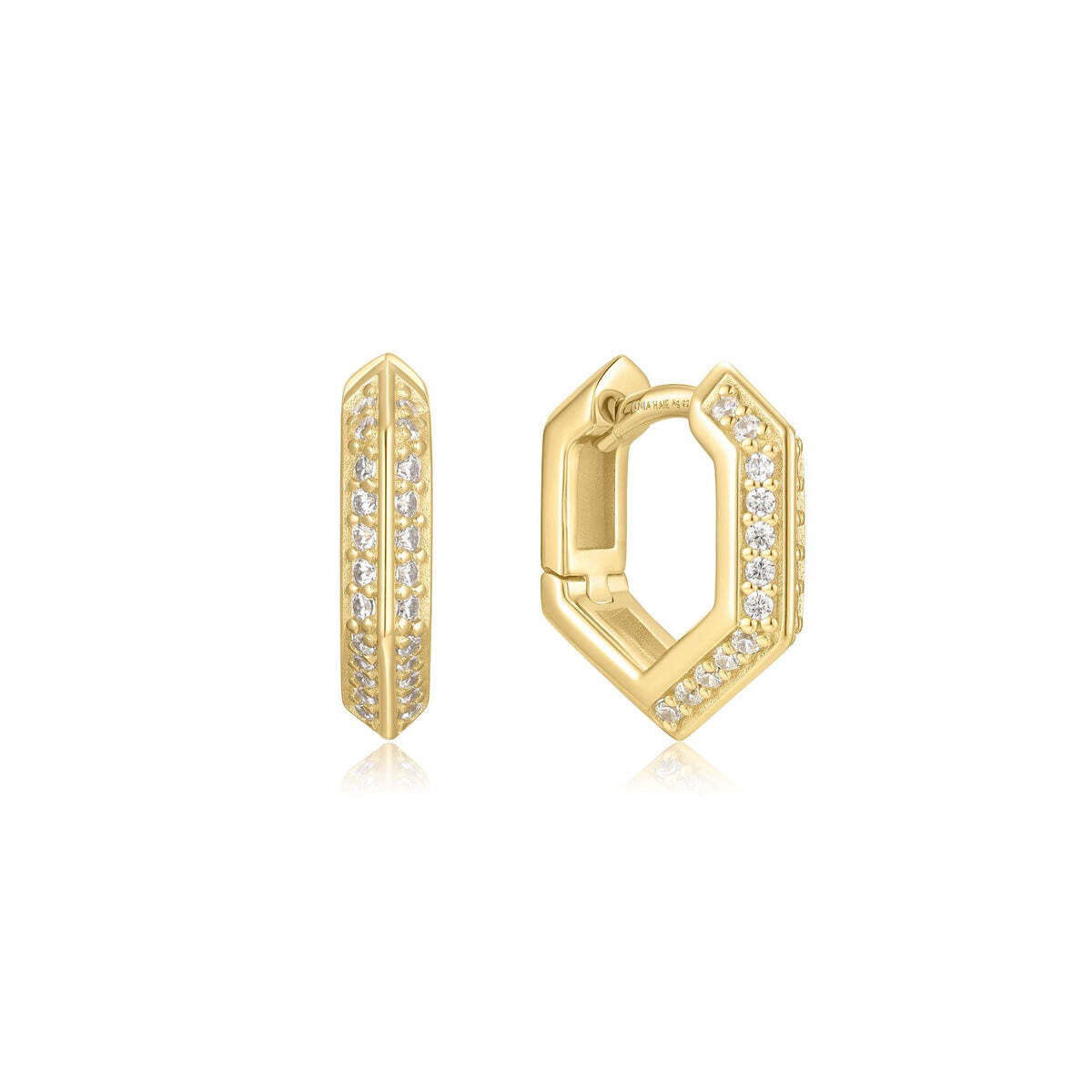 Product Description: Ready to take on the world this season? Embrace your inner strength and confidence with these sparkling shield huggies. Designed for the fearless woman who commands attention. Mix and match with other studs, huggies and hoops to making a statement. Product Details: ? Material: 925 Sterling Silver w Gold Sparkling Shield Huggie Hoop Earrings– Ania Haie US