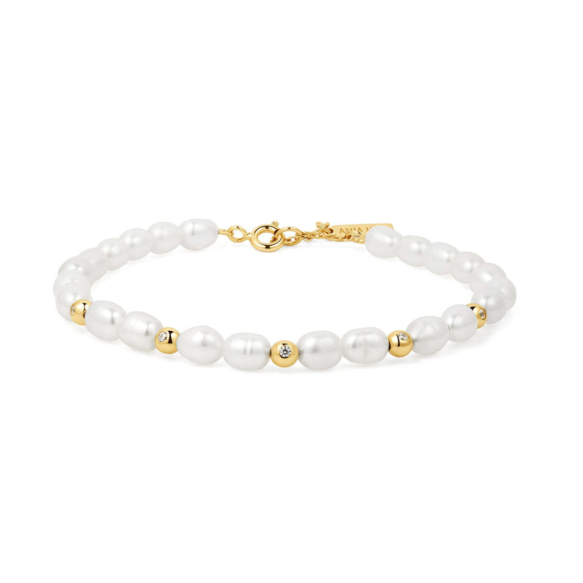 Product Description: Go for timeless elegance when you choose our freshwater pearl bracelet. This design takes a classic shape and reinvents it with a mix of pearls and 14kt gold-plated sterling silver beads. To add a touch of sparkle, you'll find the cubic zirconia covered on each silver bead. Product Details: • Mater Gold Freshwater Pearl and White Cubic Zirconia Bezel Set Bracelet– Ania Haie US