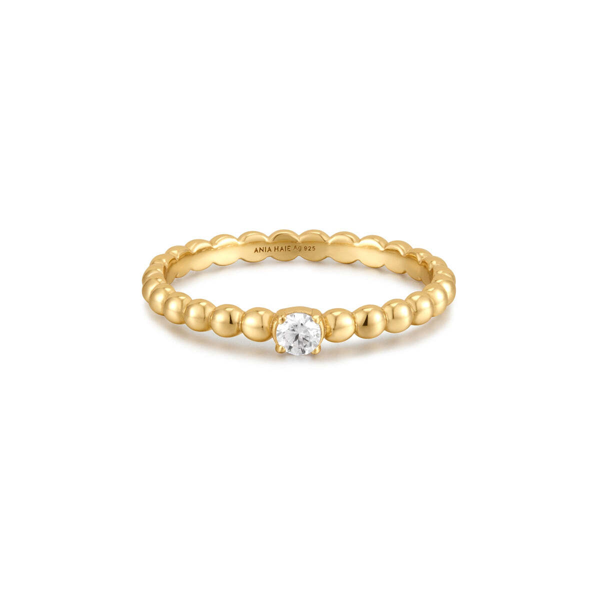 Product Description: You'll definitely fall in love with our adorable plump ring. Made of multiple spheres connected together, this ring features a cubic zirconia stone set in the center of a band in 14kt gold-plated sterling silver. Stack it up with yours, effortlessly suiting your daily looks. Product Details: • Mate Gold Cubic Zirconia Round Dome Ring– Ania Haie US