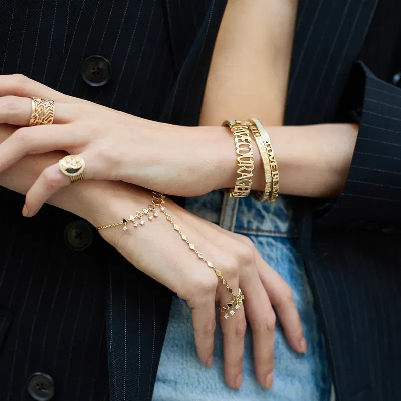 Gold bracelets and rings worn together