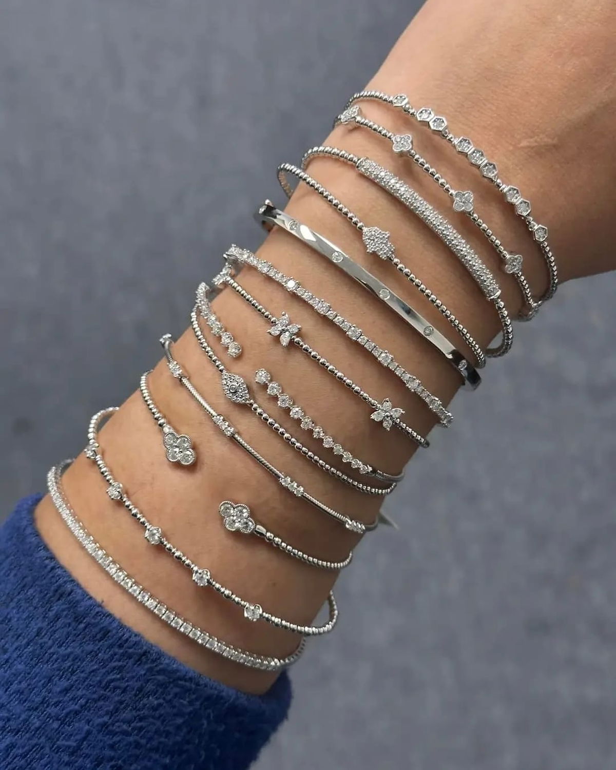 A stack of diamond bracelets on the wrist