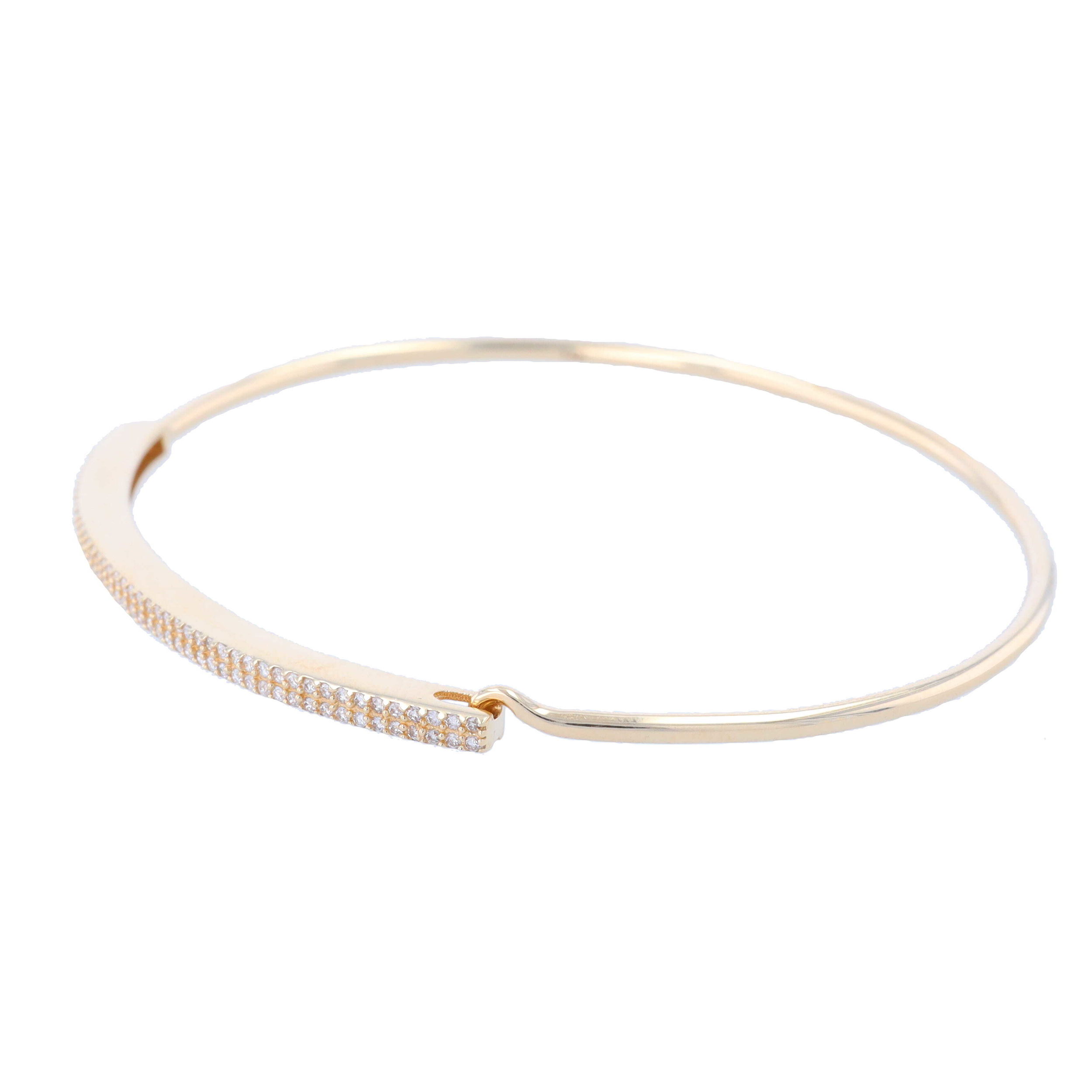 Experience the beauty of classic style with our LaNae 14k Double Pave Row Tension Bangle. Crafted in 14k gold, this timeless design shines with shimmering diamond accents along two rows on the elongated oval shape. An adjustable tension setting ensures your bangle is easy to get on while providing a secure fit. This eye-catching design adds a hint of sparkle to any look and is perfect for both day and night looks. 98 Total DiamondsDIA: 0.35tcw14k: 5.00g 14k Double Pave Row Tension Bangle